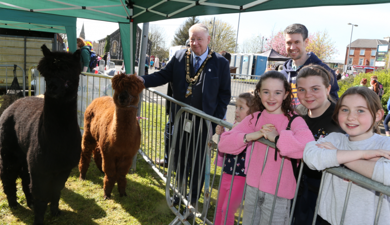 Mayor of Causeway Coast and Glens Councillor Steven Callaghan joins some of the people who attended Ballymoney Spring Fair, they are pictured visiting lamas.