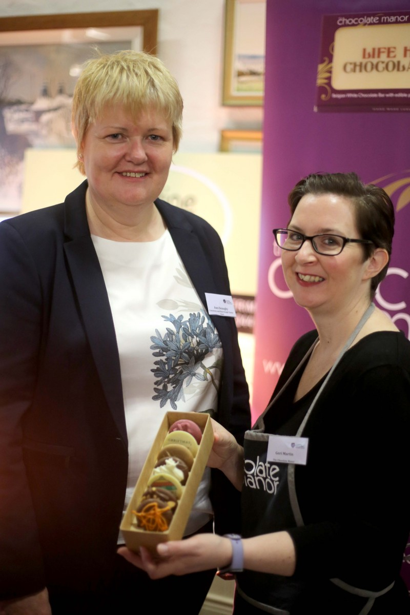 Geri Martin from The Chocolate Manor shows some of her products to Anne Donaghy, Chair of Causeway and Binevenagh Cluster.